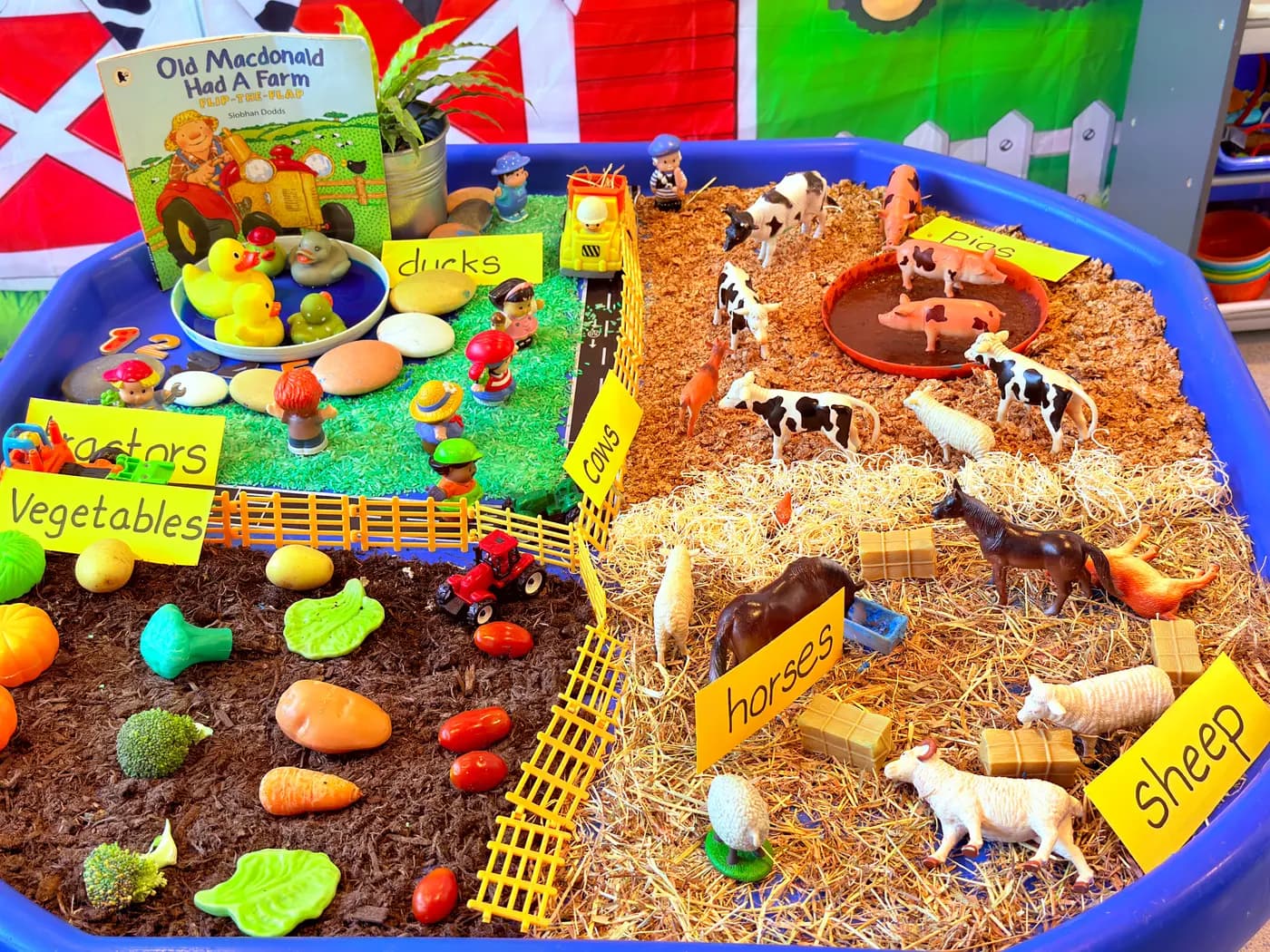 A colourful small-world village and animal display set up for imaginative play at Blue Nest Montessori Harrow