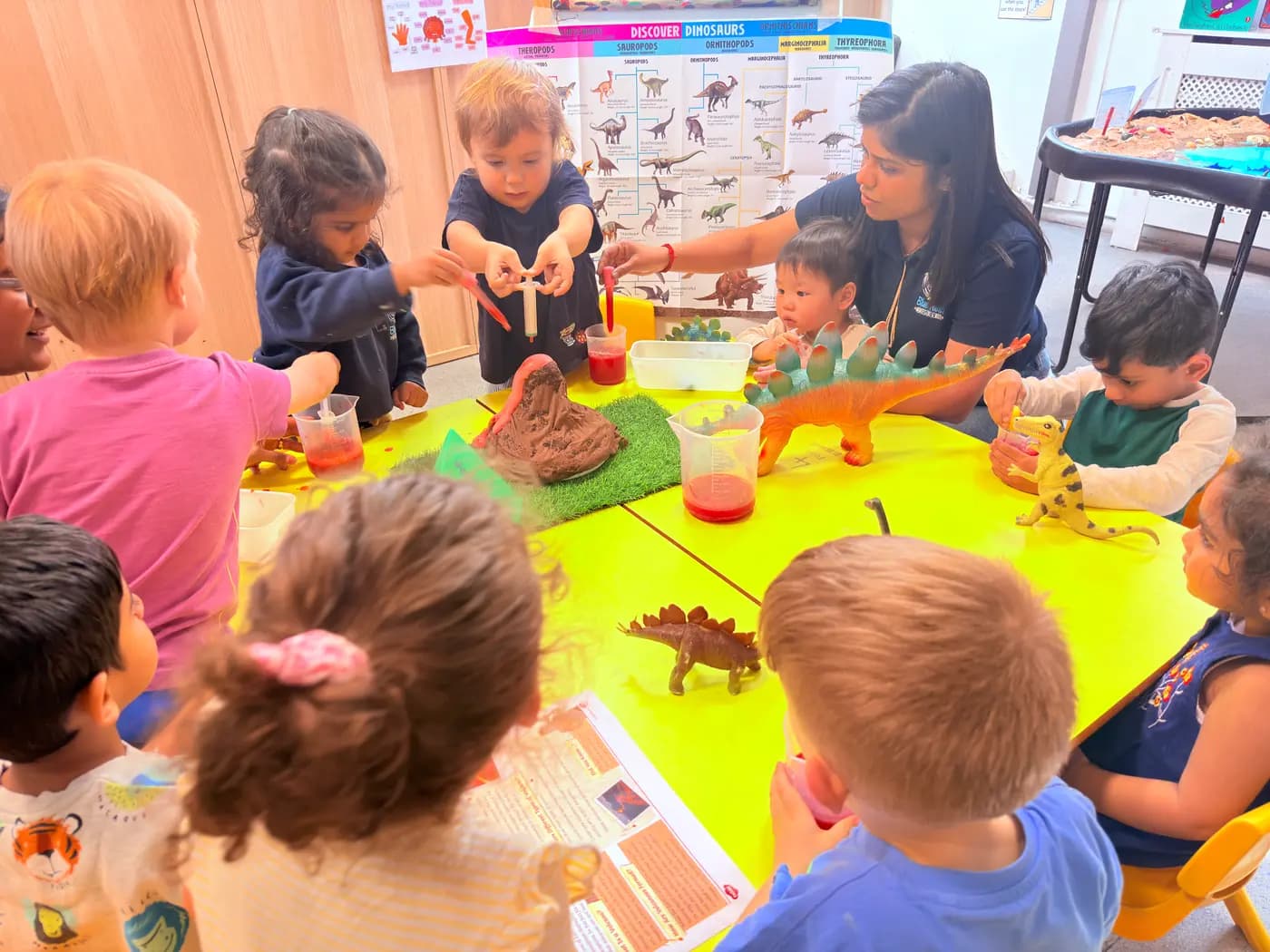 Children together at a group snack-time table at Blue Nest Montessori Harrow