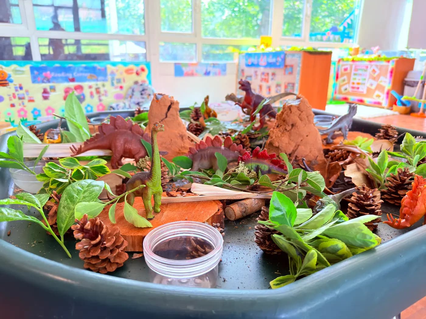An educator and children at a tabletop activity at Blue Nest Pinner