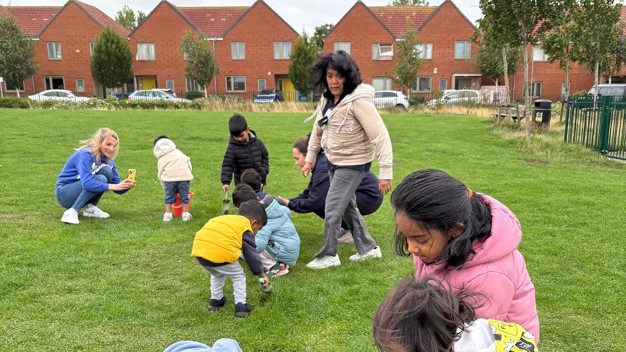 Children and families taking part in a Blue Nest community day on the green at Headstone Green Park