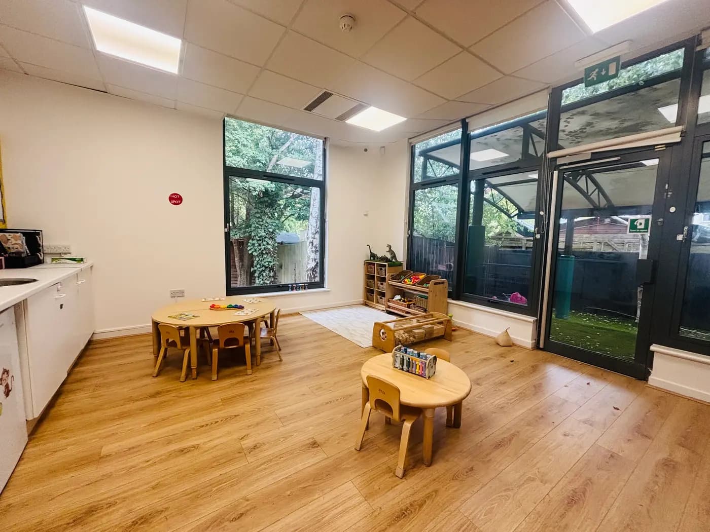 A bright toddler room with garden doors at Blue Nest Montessori Aldershot